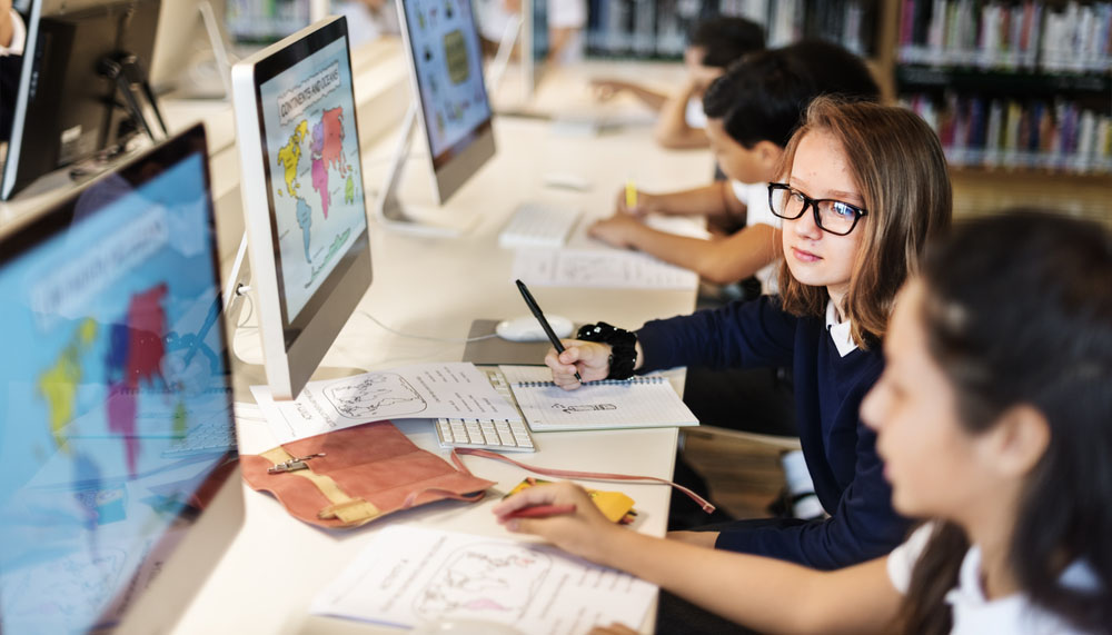 Children in classroom on desktop computers