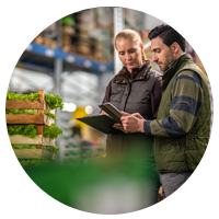 Workers in food storage view inventory and freshness information on tablet