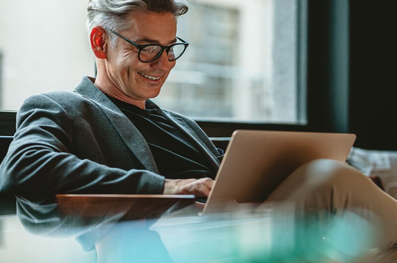 Business executive reading Gartner report on 2022 technology trends