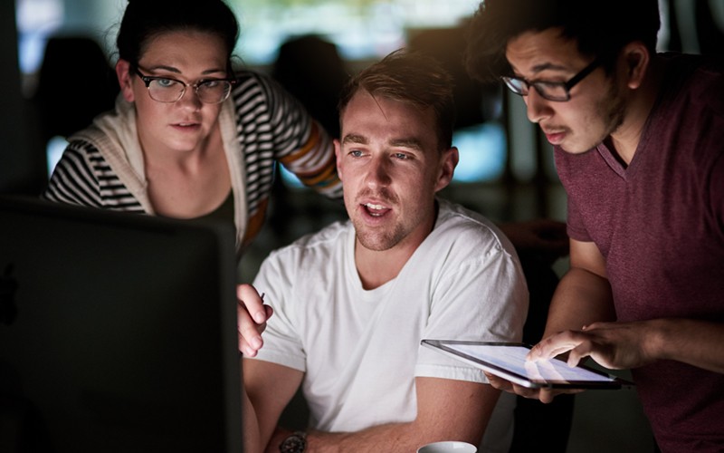 Group of colleagues working on cloud security with tablet device and computer