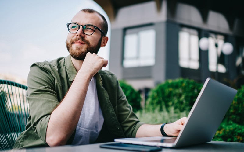Businessman on laptop device working outside remotely