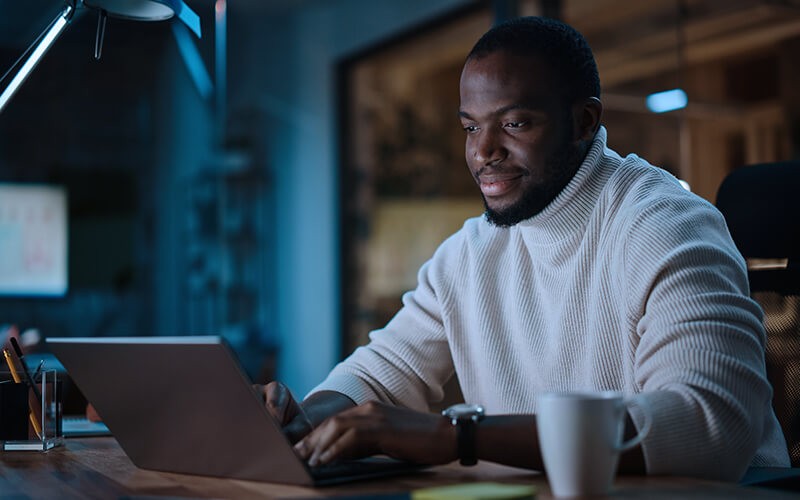 Businessman working on laptop computer at night