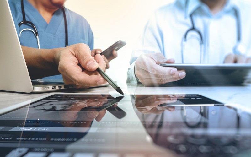 Healthcare professionals using various devices