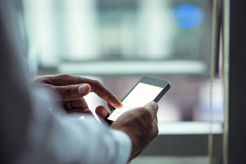 Text message communication Businessman receives company text message informing him of clients needs