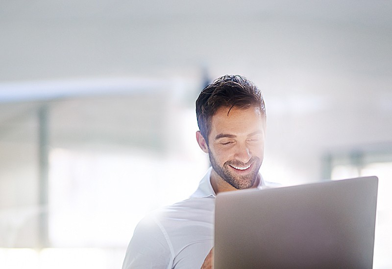 Businessman working on laptop computer in office