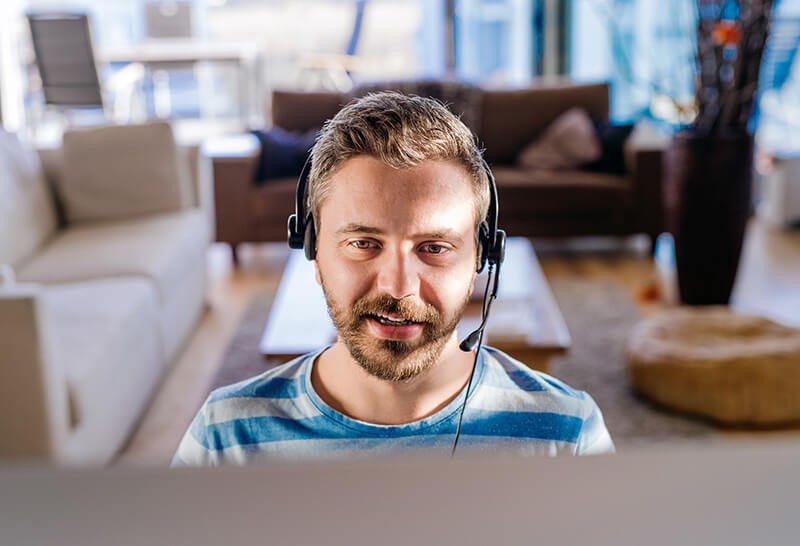 Business professional talking with team through remote conference meeting