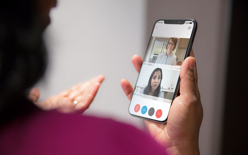 Woman on video conference call using Cisco Webex on a mobile device