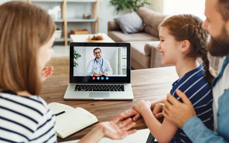 Family consults doctor through video conference call, telehealth concept
