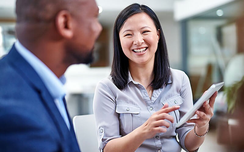 Smiling businesswoman using innovative technology solutions off tablet device