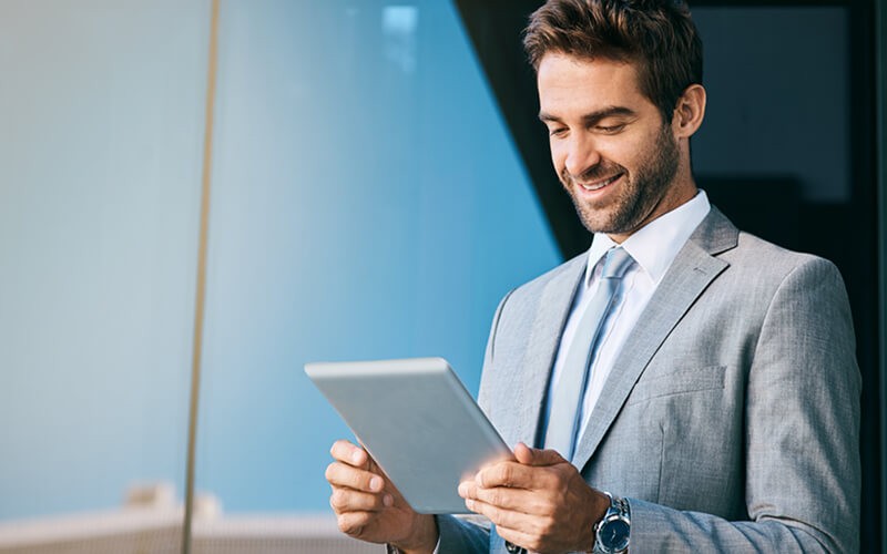 Smiling government official on tablet outside