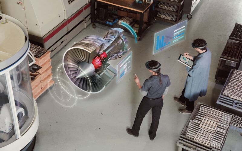 Small business professional using Microsoft HoloLens with colleague