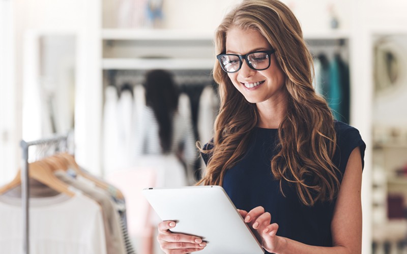 Retail customer on tablet device in clothing store