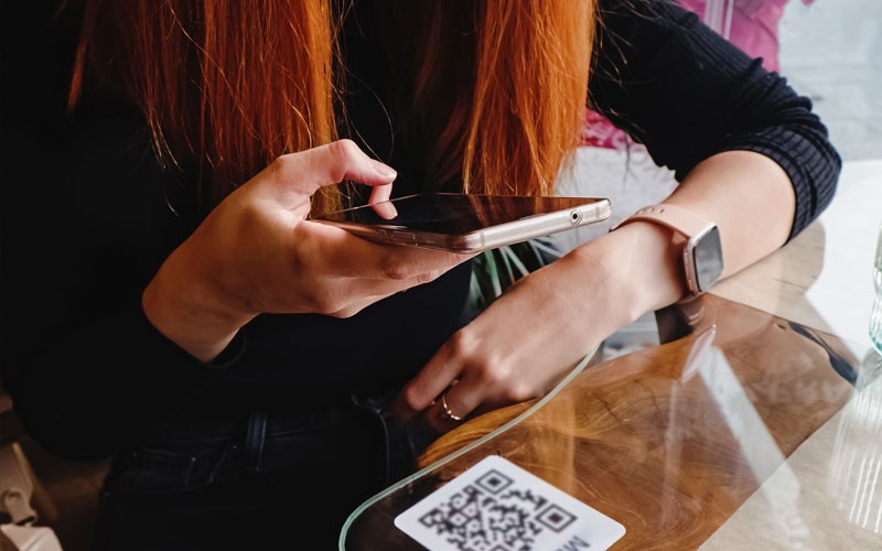 Restaurant customer uses QR code to view menu digitally 