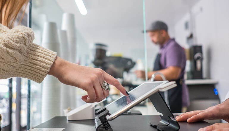 Woman using touch screen in retail store
